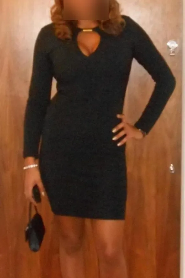 Maya in a smart black cocktail dress looking sexy